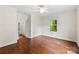 Bright bedroom with hardwood floors and large window overlooking green outdoor space at 805 S Main St, Mount Holly, NC 28120