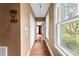 Hallway with hardwood floors, neutral paint, and natural light from the windows at 805 S Main St, Mount Holly, NC 28120