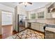 Updated kitchen featuring stainless steel appliances, white cabinets, decorative floors and a stainless steel refrigerator at 805 S Main St, Mount Holly, NC 28120