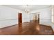 Spacious living room featuring hardwood floors with direct access to the kitchen and fireplace room at 805 S Main St, Mount Holly, NC 28120