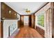 Living room featuring wood paneling, a painted fireplace, and hardwood floors at 805 S Main St, Mount Holly, NC 28120