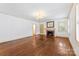 This living room features a lovely brick fireplace, beautiful hardwood floors and natural light at 805 S Main St, Mount Holly, NC 28120
