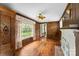 Living room featuring wood paneling, decorative sconces, and hardwood floors at 805 S Main St, Mount Holly, NC 28120