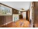 Living room featuring wood paneling, fireplace, and hardwood floors at 805 S Main St, Mount Holly, NC 28120