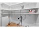 Utility room with shelving, plumbing, and clean white walls at 805 S Main St, Mount Holly, NC 28120