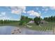 Expansive aerial view showcasing the property with a lake, dock, fire pit, and well-maintained lawn at 8283 Long Island Rd, Catawba, NC 28609