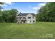 A spacious backyard with a view of the home's rear exterior and surrounding trees at 8283 Long Island Rd, Catawba, NC 28609