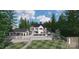 Stunning backyard view featuring a pool, outdoor kitchen, lush landscaping, and a charming two-story white house at 8283 Long Island Rd, Catawba, NC 28609