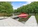 Dock with powerboat surrounded by green trees and calm waters at 8283 Long Island Rd, Catawba, NC 28609
