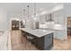 Open kitchen with white cabinetry, stainless steel appliances, a large island, and hardwood floors at 8283 Long Island Rd, Catawba, NC 28609