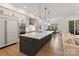 Open kitchen with white cabinetry, stainless steel appliances, a large island, and a view to the dining room at 8283 Long Island Rd, Catawba, NC 28609