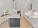 Bright kitchen features a large island, white cabinets, stainless steel appliances, and hardwood floors at 8283 Long Island Rd, Catawba, NC 28609