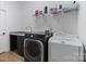 This laundry room includes modern appliances, a counter, and shelving for storage at 8283 Long Island Rd, Catawba, NC 28609