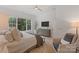 The spacious main bedroom is naturally lit and includes an upholstered chair at 8283 Long Island Rd, Catawba, NC 28609