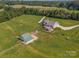 Aerial shot of a well-maintained estate with a house, barn, and fenced pasture at 830 John Rainey Rd, Salisbury, NC 28147