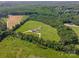 Stunning aerial view of an estate home on a large acreage with mature trees and a lush lawn at 830 John Rainey Rd, Salisbury, NC 28147