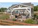 Outdoor patio area with built-in grill, hot tub, and comfortable seating under a pergola at 830 John Rainey Rd, Salisbury, NC 28147