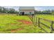 A horse barn with green trim is centered on a pasture with fencing at 830 John Rainey Rd, Salisbury, NC 28147
