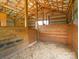 Wood-constructed barn interior with individual stalls for livestock at 830 John Rainey Rd, Salisbury, NC 28147