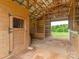 Barn interior showcasing wooden stalls, metal gates, and ample space for livestock at 830 John Rainey Rd, Salisbury, NC 28147