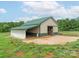 Well-maintained barn featuring a green roof and a spacious, partially enclosed area at 830 John Rainey Rd, Salisbury, NC 28147
