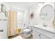 Bright bathroom features a tub-shower combination and a round mirror over a white vanity at 830 John Rainey Rd, Salisbury, NC 28147