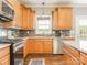 Charming kitchen featuring custom wood cabinetry, modern appliances, and granite countertops at 830 John Rainey Rd, Salisbury, NC 28147