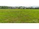 Expansive grassy lot with a modern farmhouse and barn in the background, perfect for outdoor activities and country living at 830 John Rainey Rd, Salisbury, NC 28147