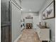 A well-organized laundry room with barn door, washer/dryer, and a decorative dresser at 830 John Rainey Rd, Salisbury, NC 28147
