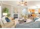 Bright living room featuring hardwood floors, a fireplace, neutral walls, and contemporary furnishings at 830 John Rainey Rd, Salisbury, NC 28147