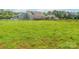 Green field, a home and barn, and equestrian fencing in a large horse pasture at 830 John Rainey Rd, Salisbury, NC 28147