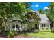 Charming home with a well-manicured lawn and inviting front porch nestled among mature trees at 833 Lemond Ln, Denver, NC 28037