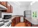 Well-lit kitchen featuring wood cabinets, stainless steel refrigerator, and an island at 833 Lemond Ln, Denver, NC 28037