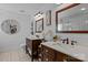 Stylish bathroom featuring double vanity with vessel sinks, white walls, and modern fixtures at 8700 Fox Tail Ln, Huntersville, NC 28078