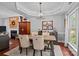 Dining area with a rustic wood table, fireplace, and view to the living area at 8700 Fox Tail Ln, Huntersville, NC 28078