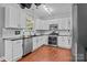 Bright kitchen with white cabinets, stainless steel appliances, and black countertops at 8700 Fox Tail Ln, Huntersville, NC 28078