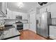 Modern kitchen featuring white cabinets, stainless steel appliances, and dark countertops at 8700 Fox Tail Ln, Huntersville, NC 28078
