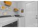 Well-organized laundry room with modern appliances, shelving, and white walls at 8700 Fox Tail Ln, Huntersville, NC 28078