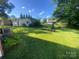Green backyard featuring a garden, shed, and various trees at 903 Woodside Dr, Kings Mountain, NC 28086