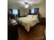 Comfortable bedroom featuring dark wood furnishings, a fan, and bright natural lighting at 903 Woodside Dr, Kings Mountain, NC 28086
