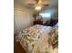 Bright bedroom featuring a floral bedspread, hardwood floors and ample closet space at 903 Woodside Dr, Kings Mountain, NC 28086