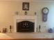 Classic white fireplace with mantle, brick surround, and decorative accents providing a focal point in the living room at 903 Woodside Dr, Kings Mountain, NC 28086