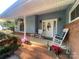 Inviting front porch with rocking chairs, hanging flower baskets, and a decorative wreath on the front door at 903 Woodside Dr, Kings Mountain, NC 28086