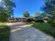 Charming single-story home with a long driveway and a well-maintained lawn under a clear blue sky at 903 Woodside Dr, Kings Mountain, NC 28086