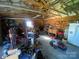 A cluttered garage interior filled with woodworking tools, furniture, and equipment at 903 Woodside Dr, Kings Mountain, NC 28086