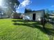 A detached yellow garage, accessible from the home's grassy, fenced backyard at 903 Woodside Dr, Kings Mountain, NC 28086
