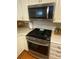 Modern stainless steel stove and microwave compliment the white cabinetry and subway tile backsplash in kitchen at 903 Woodside Dr, Kings Mountain, NC 28086