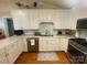 Bright kitchen features white cabinets, stainless steel appliances, quartz countertops, and hardwood floors at 903 Woodside Dr, Kings Mountain, NC 28086