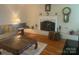 Comfortable living room featuring a white brick fireplace, hardwood floors, and ample natural light at 903 Woodside Dr, Kings Mountain, NC 28086