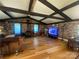Spacious living room with exposed wood beams, brick walls, hardwood floors, and a wood-burning stove at 903 Woodside Dr, Kings Mountain, NC 28086